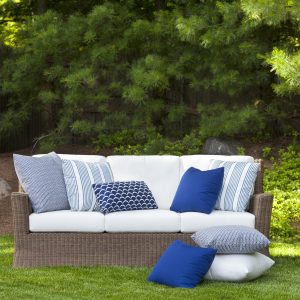 wicker outdoor sofa with white cushions